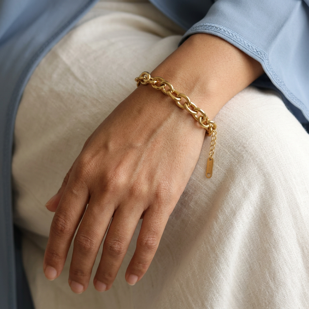 Circle Link Bracelet worn on a wrist, showing the gold-tone links and dangling extension chain with an end tag.