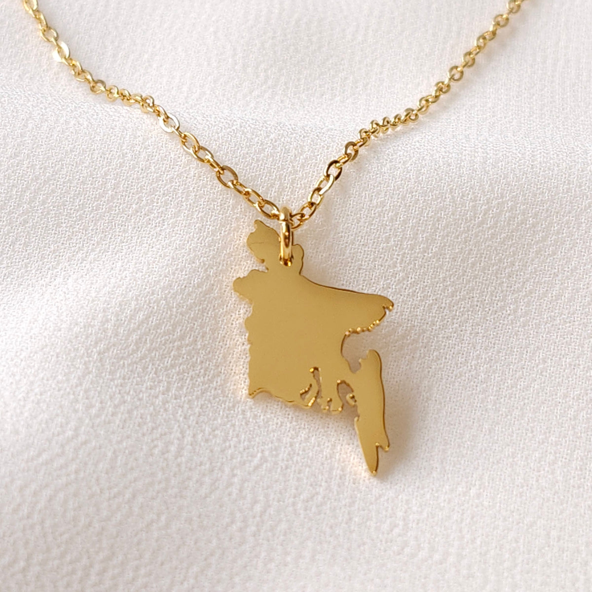 Gold-tone Bangladesh map pendant necklace with a polished silhouette.