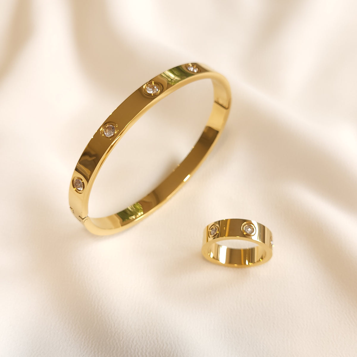 Gold-tone Crystal Stud Bangle displayed alongside a matching crystal-studded ring.