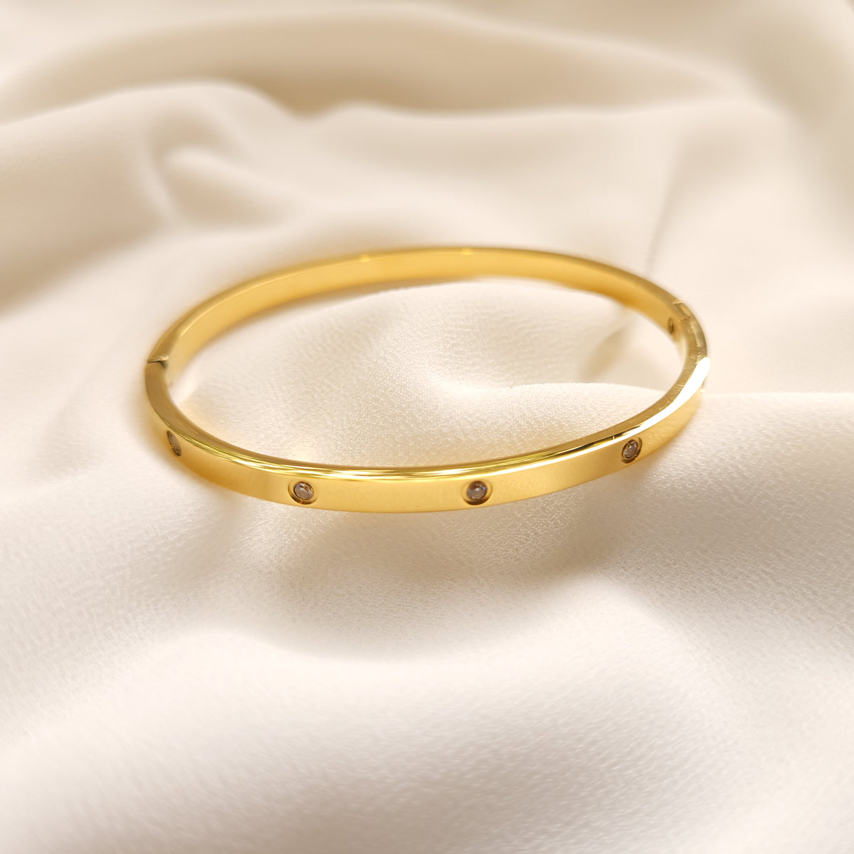 Gold-tone Crystal Stud Bangle with a slim, polished band and evenly spaced round clear stones.