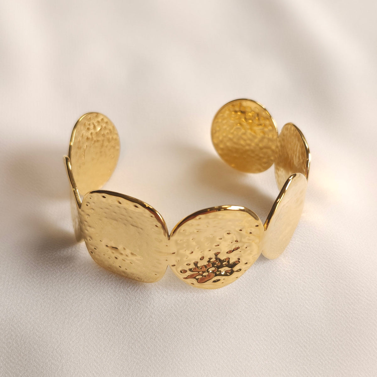 Gold Bold Disc Cuff with large hammered discs and an open-ended design.
