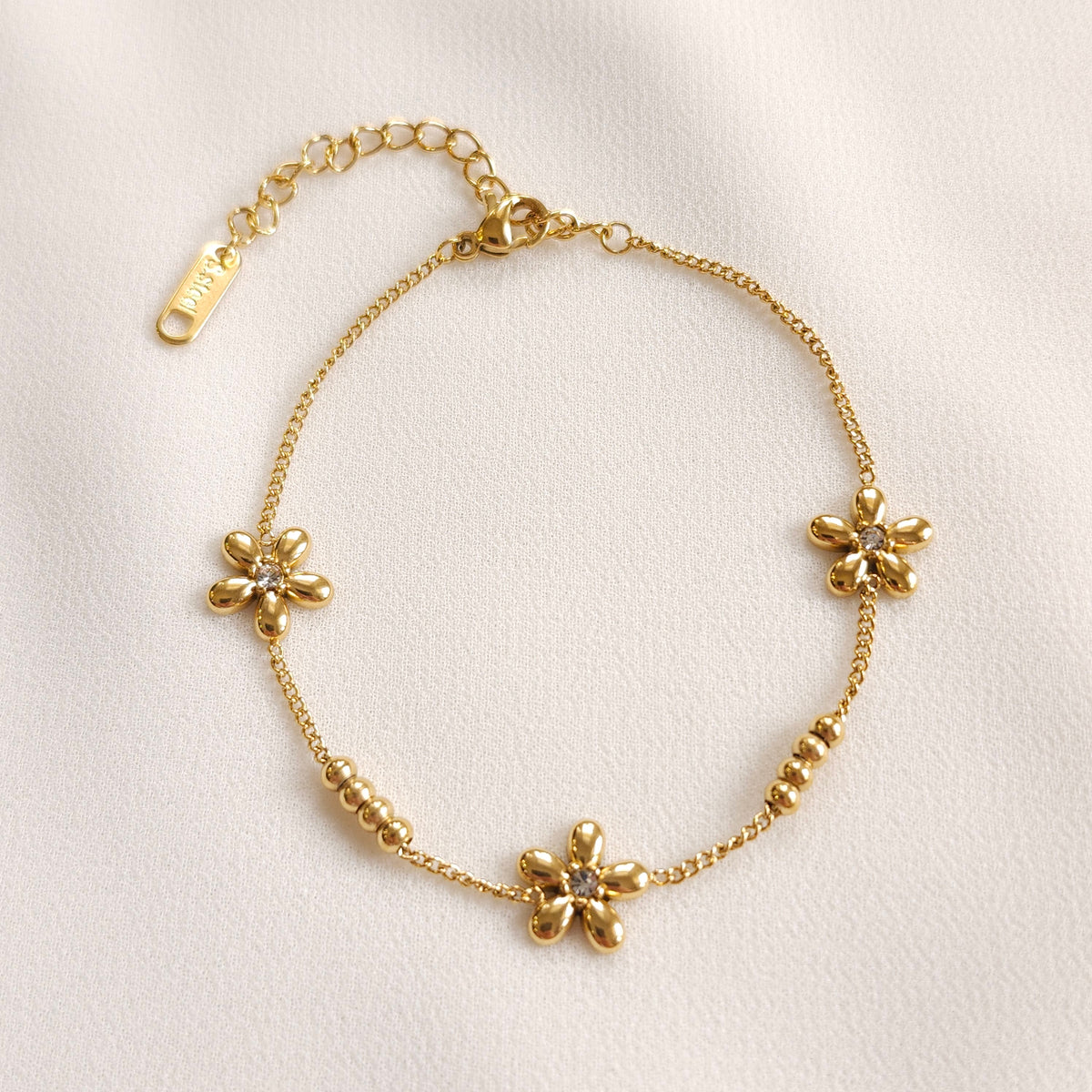 Gold Daisy Chain Bracelet with three flowers, clear centre stones and two groups of four gold beads