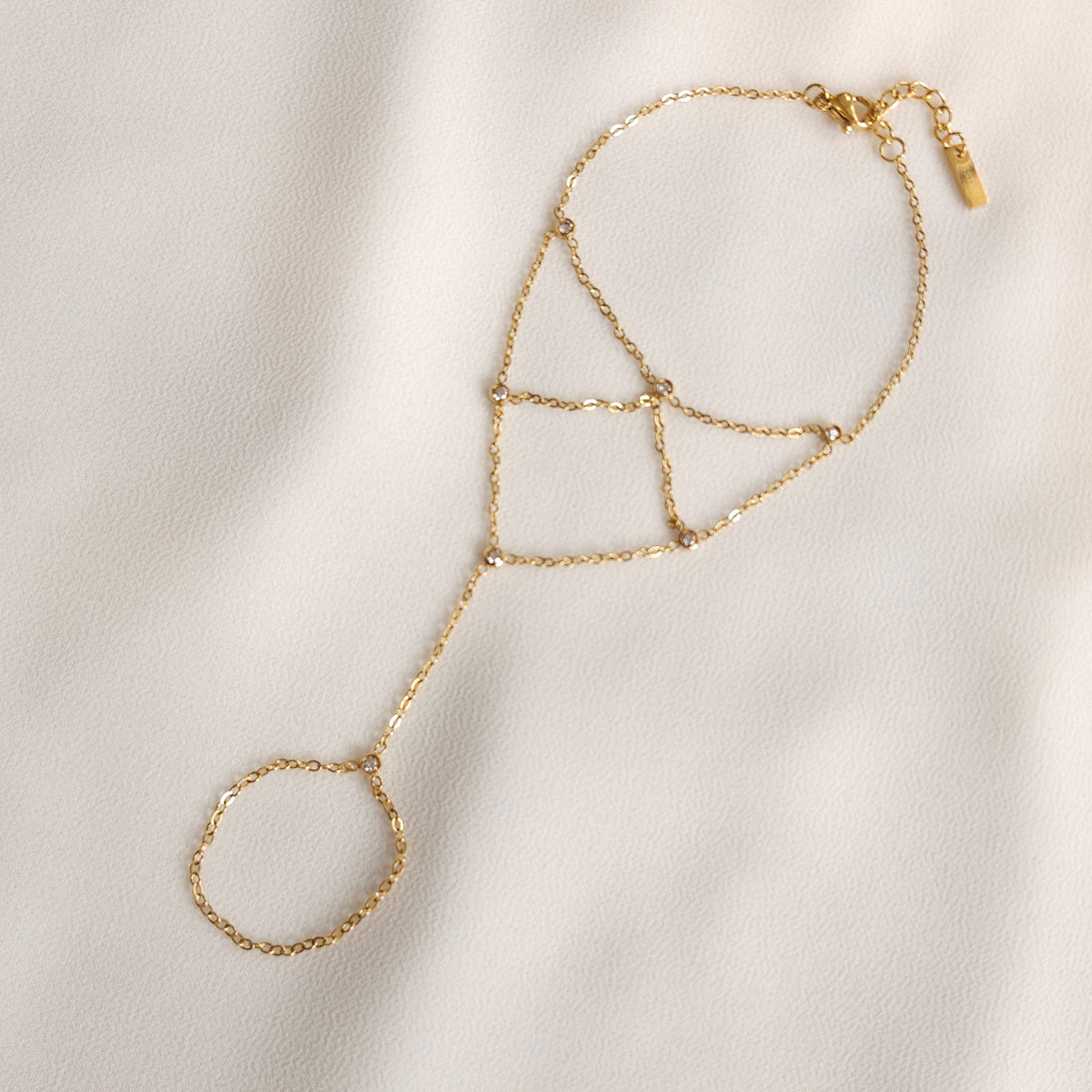 Gold Mesh Hand Chain laid flat, showing the finger loop, geometric wrist chains, clasp and extension.