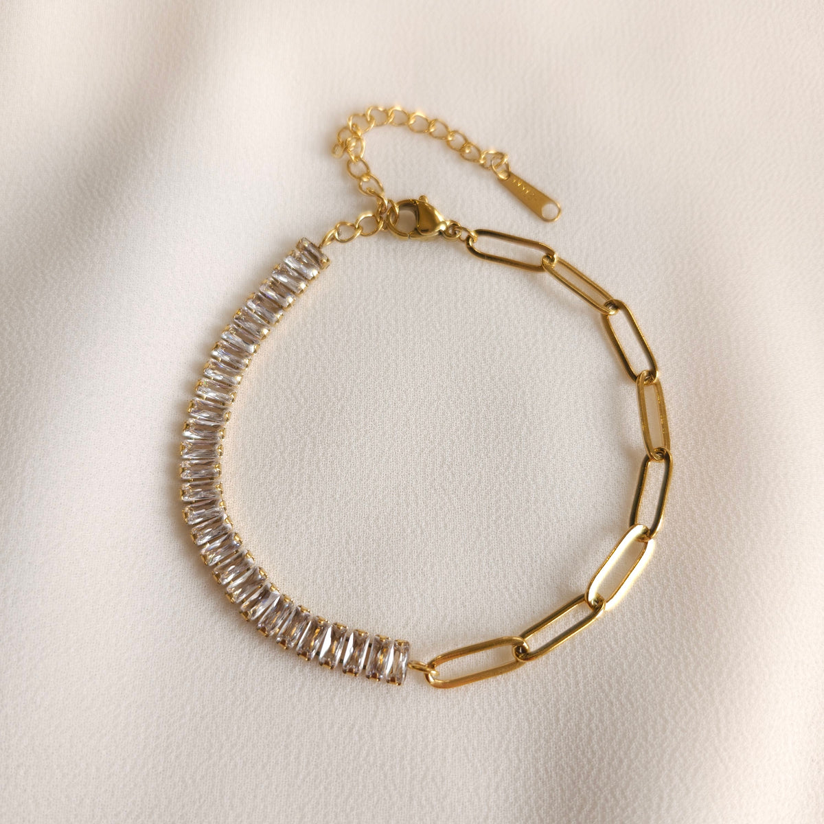 Link and Zirconia Bracelet with rectangular clear stones, large gold-tone paperclip links, a lobster clasp and extender chain.