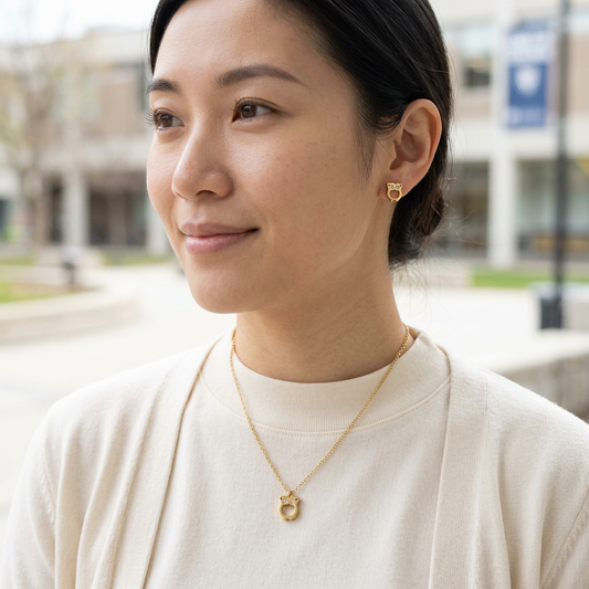 Model wearing the gold Owl Necklace and matching owl stud earrings