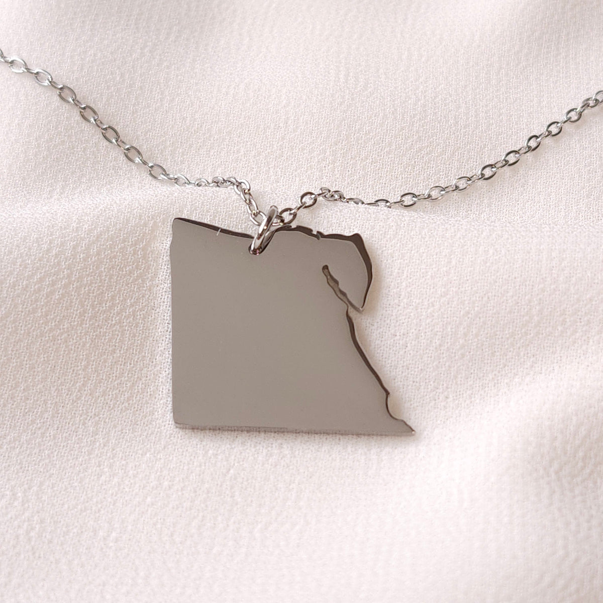 Silver-tone Egypt map pendant necklace showing the country outline and Sinai Peninsula.