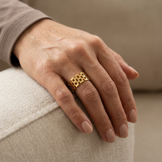 Close-up of a model’s hand wearing the gold Mesh Ring