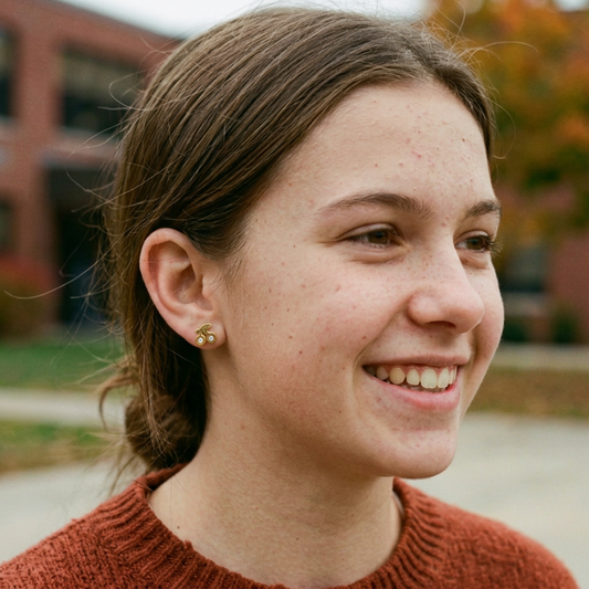 Close-up portrait wearing the gold cherry stud earrings