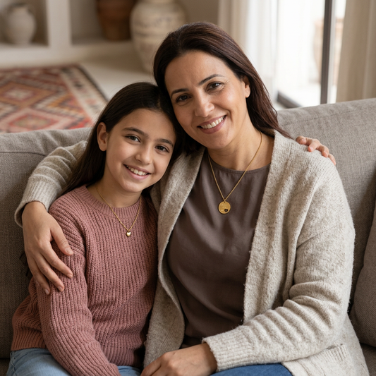Fresh mother-and-daughter portrait with a small circular pendant