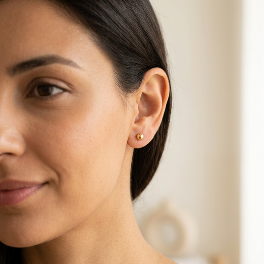Fresh square portrait with a small gold ball stud and crisp natural indoor lighting