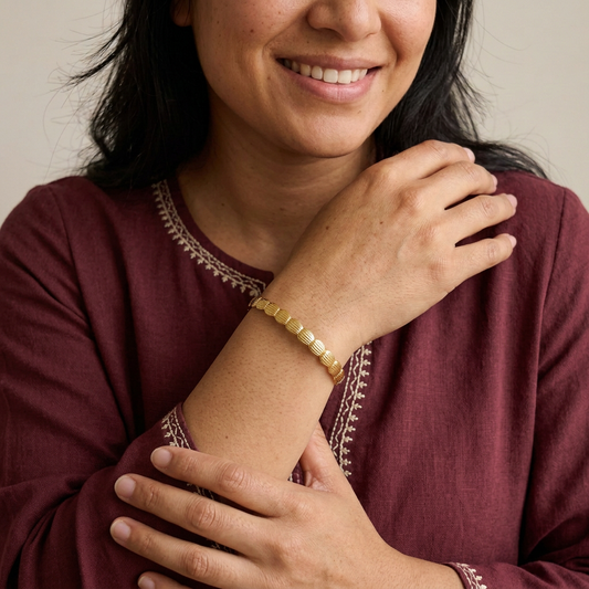 Model in traditional-inspired clothing wearing a narrower Retro Ribbed Bangle