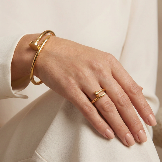 Tight square close-up of the hand wearing the gold nail ring and bangle