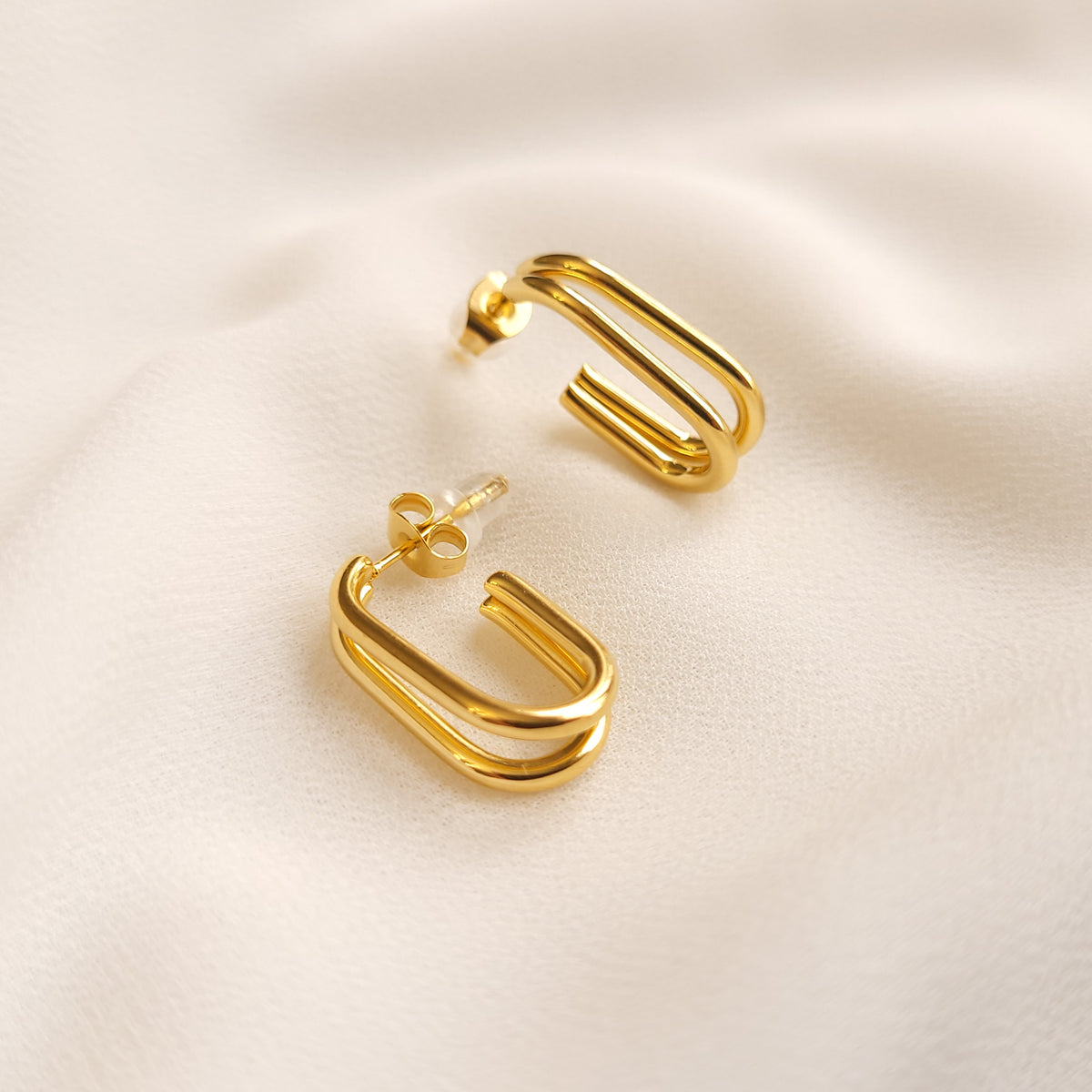 Double U-Hoop Earrings in gold tone, featuring two parallel U-shaped curves with straight posts and butterfly backs.
