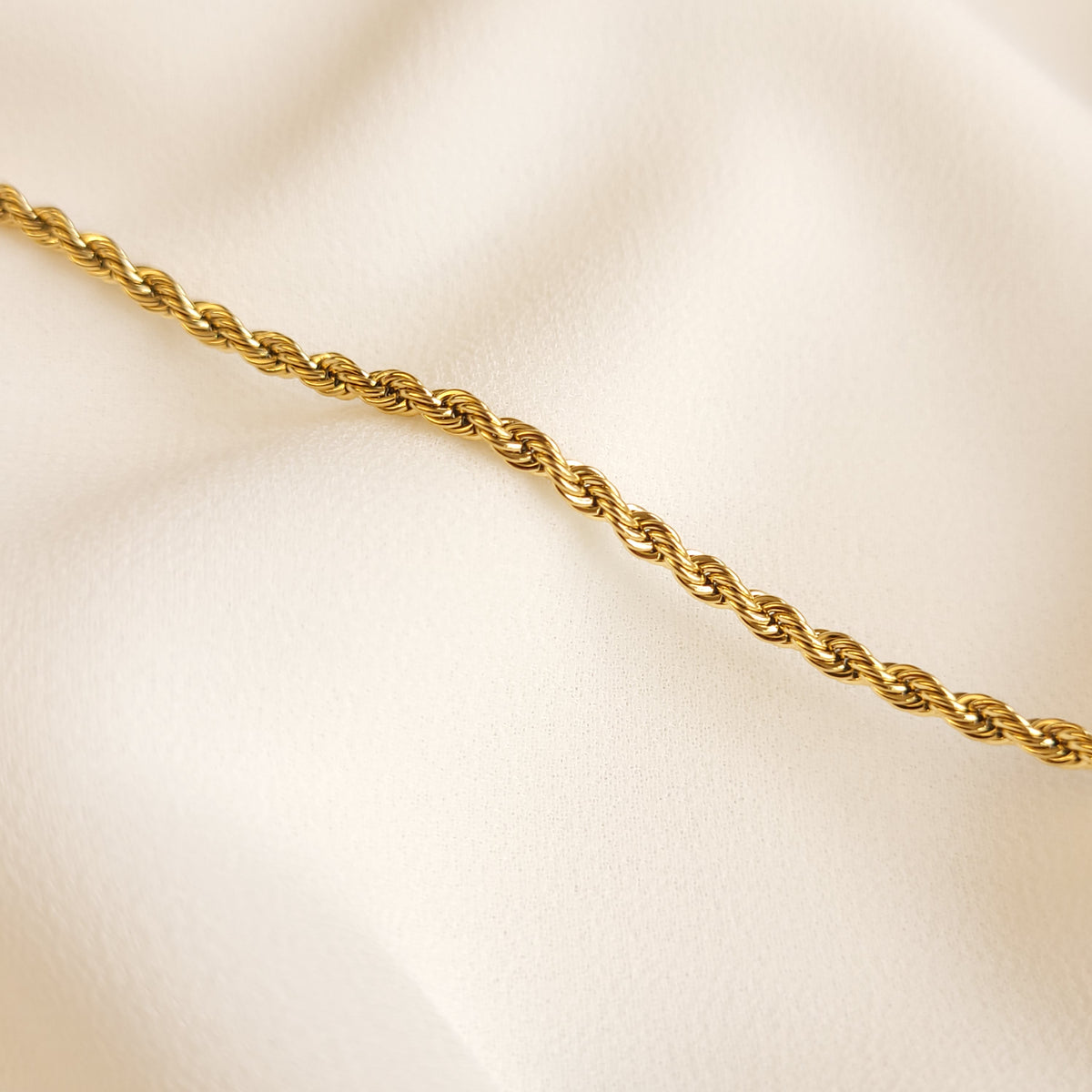 Essential Rope Necklace close-up showing the polished gold-tone links and spiral rope pattern.