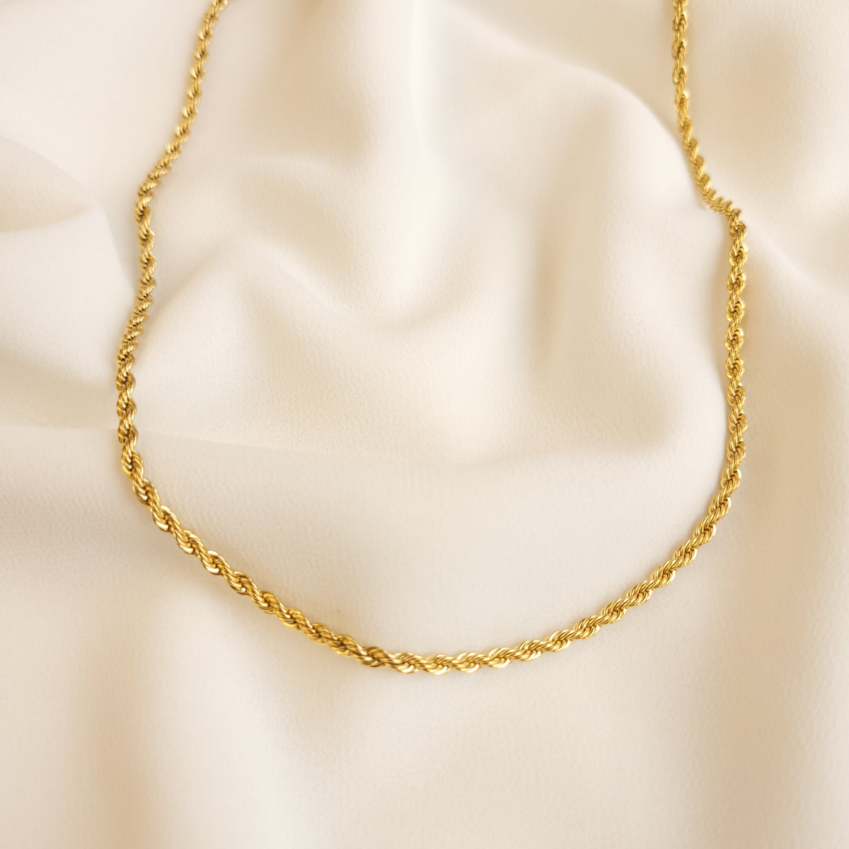 Essential Rope Necklace in gold tone, showing its slim chain of tightly intertwined rope-style links.