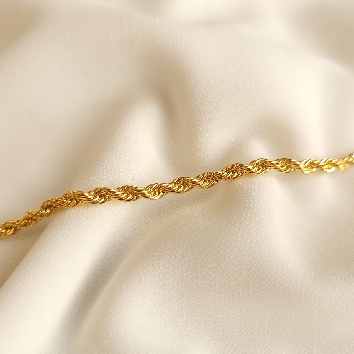 Rope Bracelet close-up showing the tightly intertwined gold-tone links and spiral pattern.