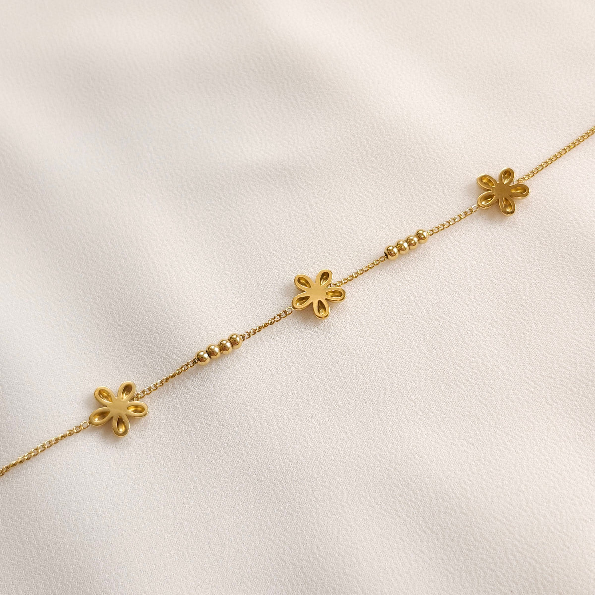 Back of the gold Daisy Chain Bracelet showing the hollow-backed flower petals and bead details
