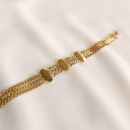 Back of the gold Trio Link Bracelet showing the flat undersides of its three oval bars.