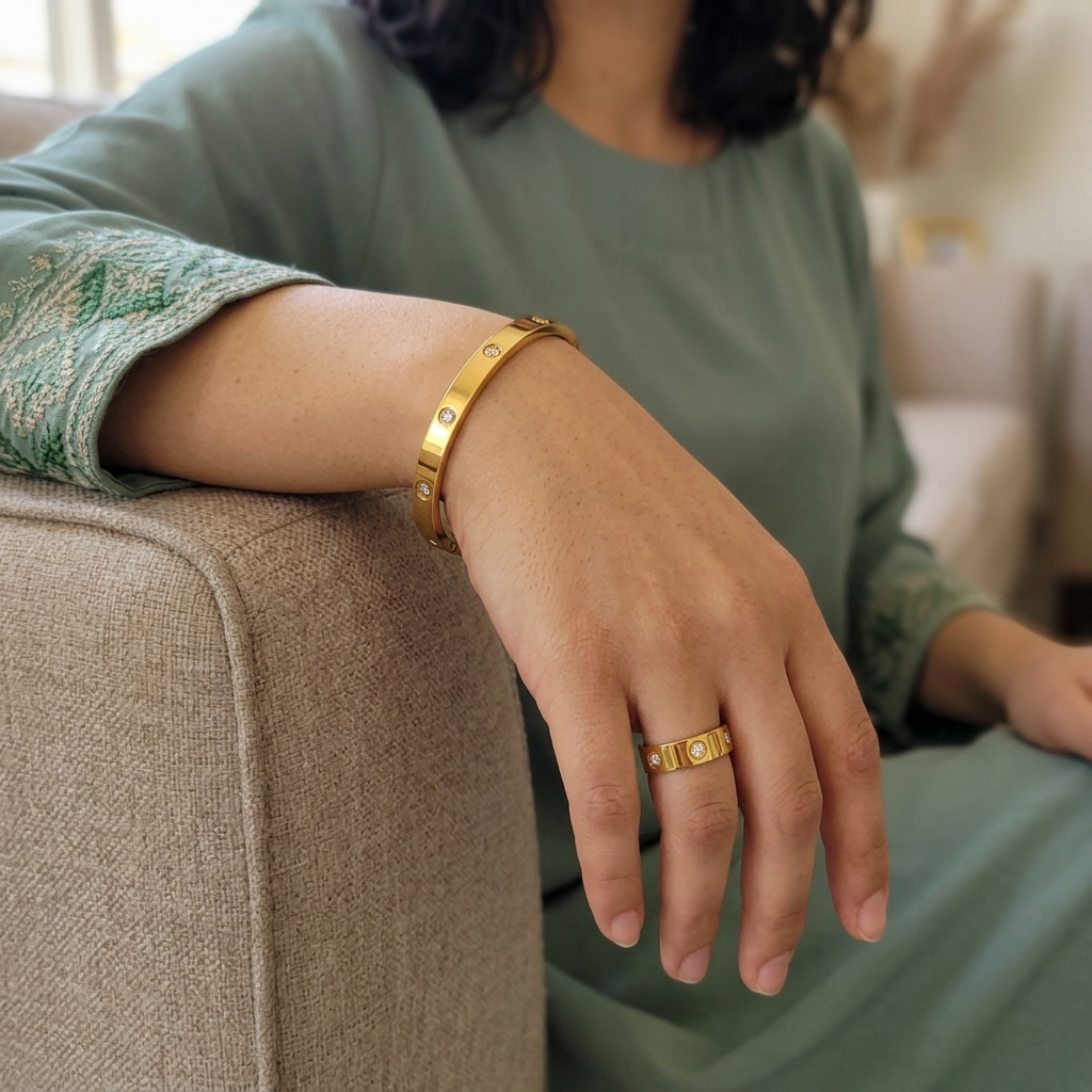 Close-up of a model wearing the gold-tone Crystal Stud Bangle with a matching ring.
