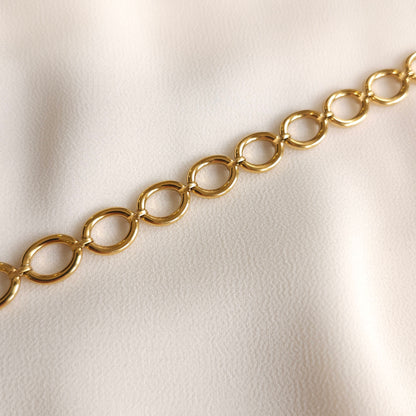 Close-up of the gold Eternal Link Bracelet showing polished oval links joined by small connectors