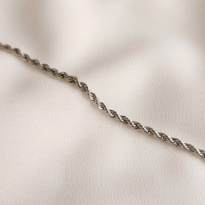 Essential Rope Necklace in silver tone, showing its slim intertwined links and polished finish.