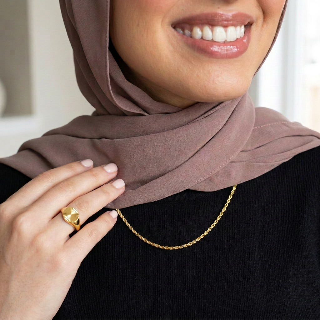 Essential Rope Necklace worn over a black top, paired with a gold-tone Starburst Signet Ring.