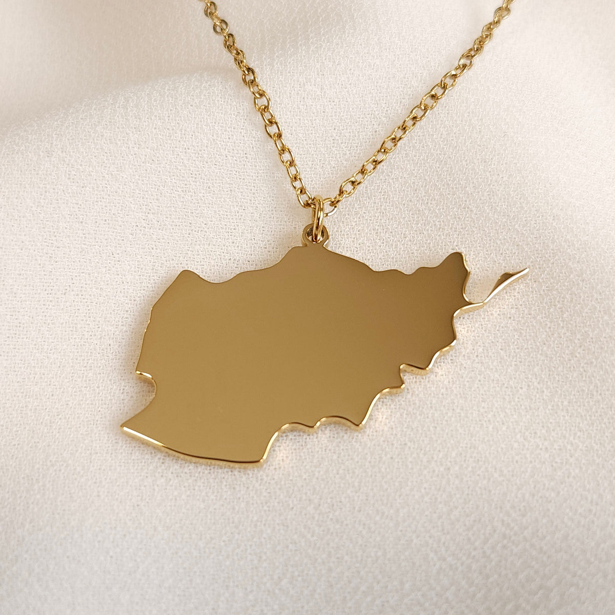 Gold-tone Afghanistan map pendant necklace with a fine oval-link chain.
