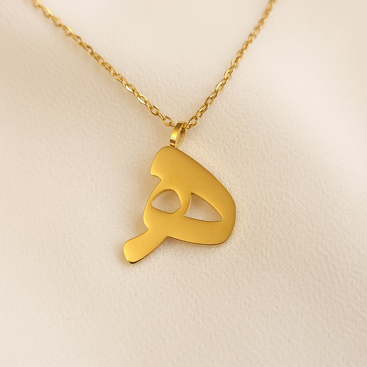 Gold-tone Arabic Initial Necklace with the letter Haa (ه) on a fine link chain.
