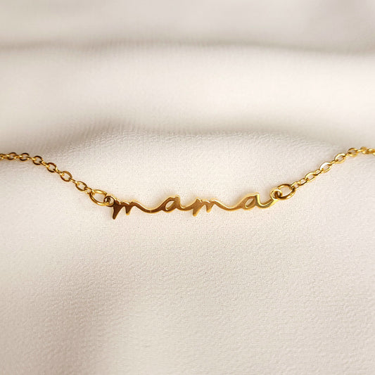 Gold-tone Cursive Mama Necklace with a lowercase “mama” script pendant on a fine link chain.
