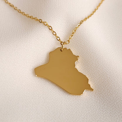 Gold-tone Iraq map pendant necklace with a polished silhouette.
