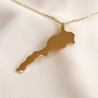 Gold-tone Morocco map pendant necklace with an elongated silhouette.
