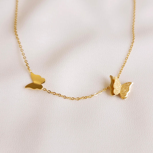 Gold-tone Sparkling Butterfly Necklace with a small polished butterfly and a larger textured butterfly on a fine link chain.
