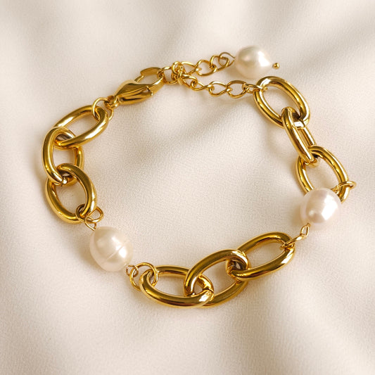 Gold Bold Pearl Chain Bracelet with chunky oval links, white pearls and an adjustable extension chain.
