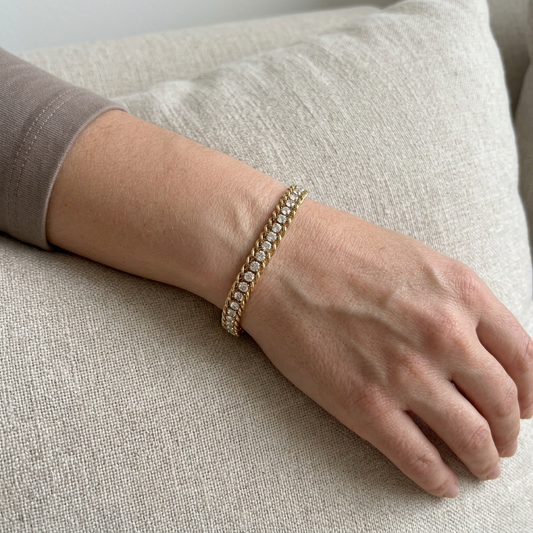 Gold Braided Crystal Link Bracelet worn on a model’s wrist, showing its clear stones and braided edges