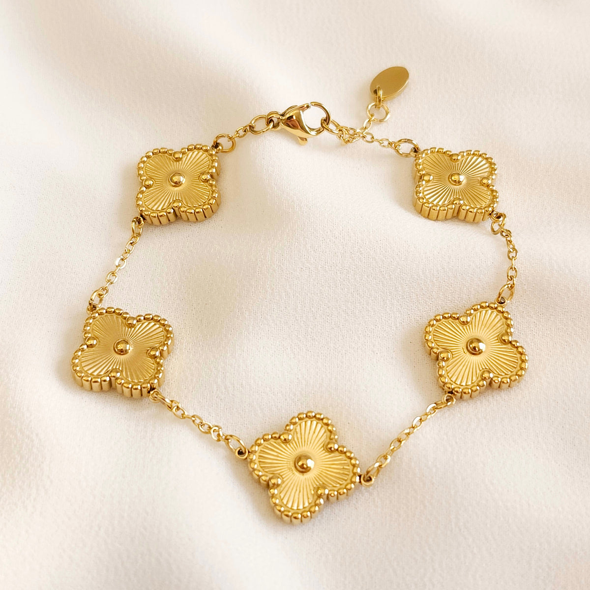 Gold Clover Bracelet with five sunburst-engraved clover charms, raised centre beads and beaded borders on a fine chain.

