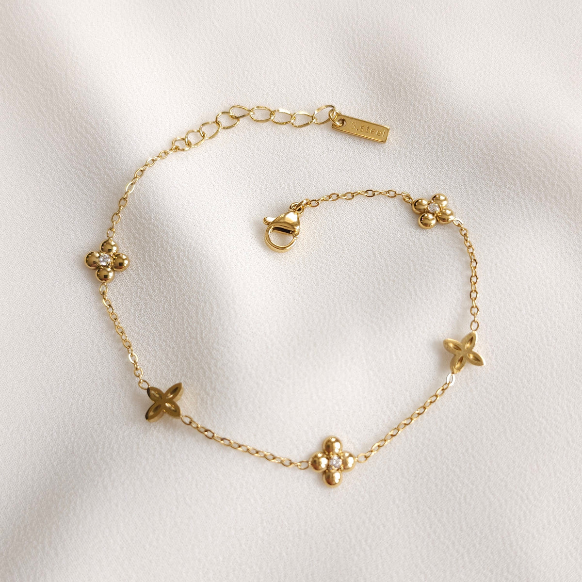 Gold Dainty Flower Bracelet with alternating floral charms, clear stone accents and an adjustable extension chain
