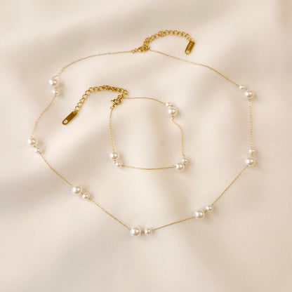 Gold Doubled Up Pearl Bracelet and matching necklace with paired white pearls and adjustable extension chains.
