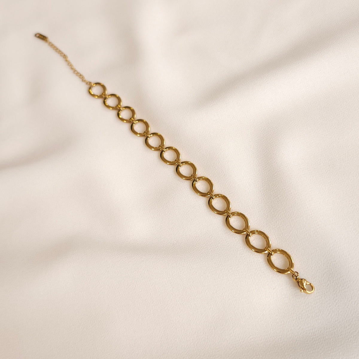 Gold Eternal Link Bracelet laid straight, showing the complete oval-link chain and adjustable clasp