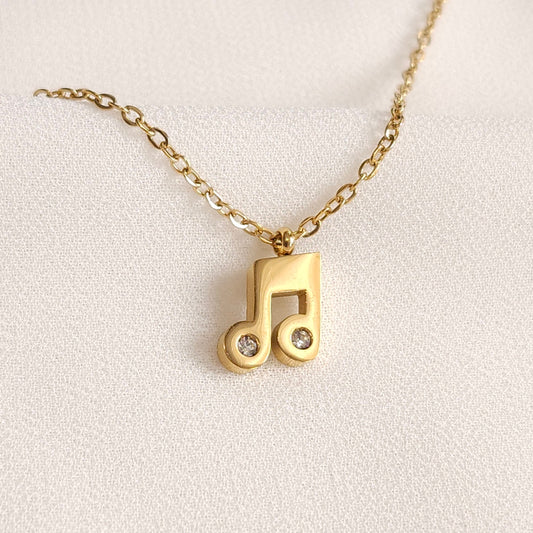 Gold Music Note Necklace with a beamed-note pendant and two clear round stones set into the note heads.