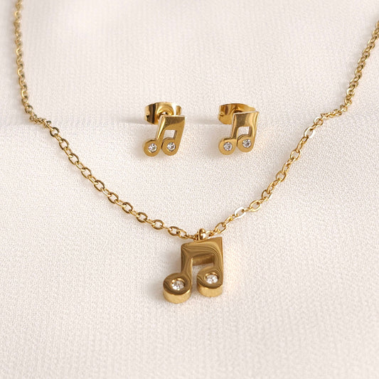 Gold Music Notes Set with a matching beamed-note pendant necklace and stud earrings accented with clear stones.