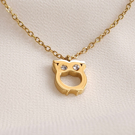 Gold Owl Necklace pendant with two clear stone eyes and an open owl-shaped outline