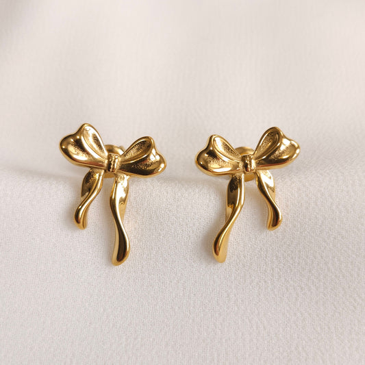 Gold Ribbon Earrings with sculpted bow loops and flowing ribbon tails.