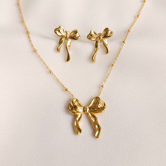 Gold Ribbon Set with a sculpted bow pendant necklace and matching bow stud earrings.