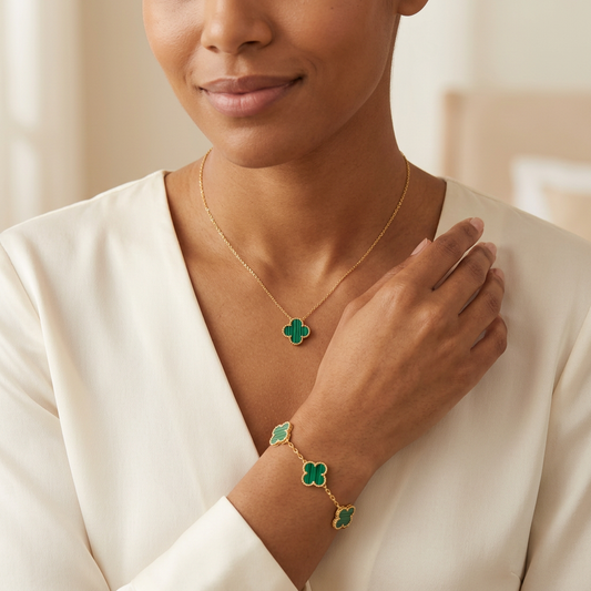 Model wearing the Vintage Green Clover Set necklace and matching gold bracelet with striped green clovers.
