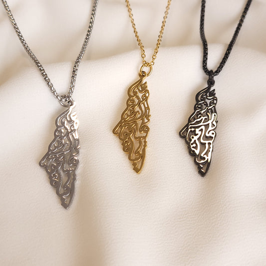 Palestine Calligraphy Necklaces in silver-tone, gold-tone and black finishes with Arabic calligraphy forming map-shaped pendants.
