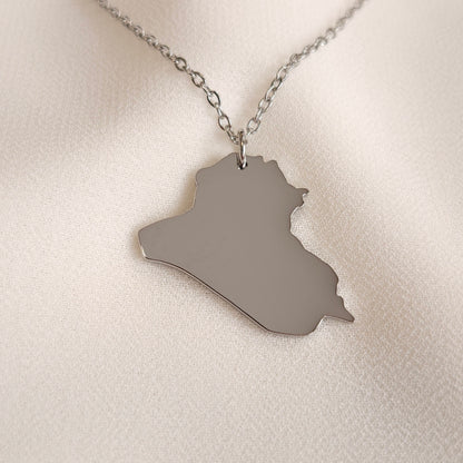 Silver-tone Iraq map pendant necklace with a fine oval-link chain.
