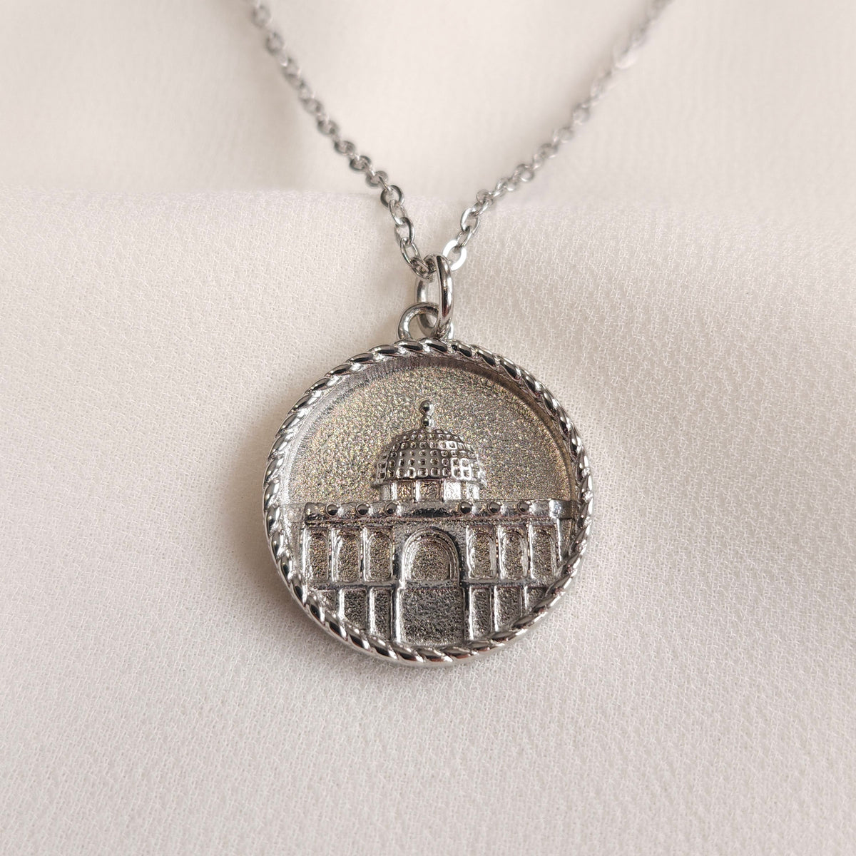 Silver Dome of the Rock Coin Necklace with a raised architectural design and twisted rope border.