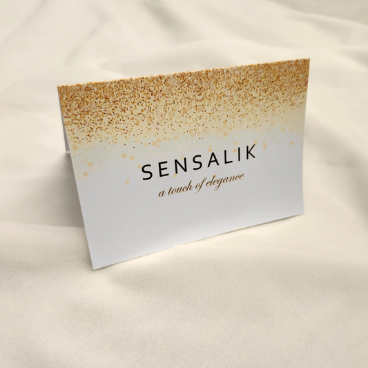 White Sensalik Message Card with a gold speckled border and the words Sensalik, a touch of elegance.
