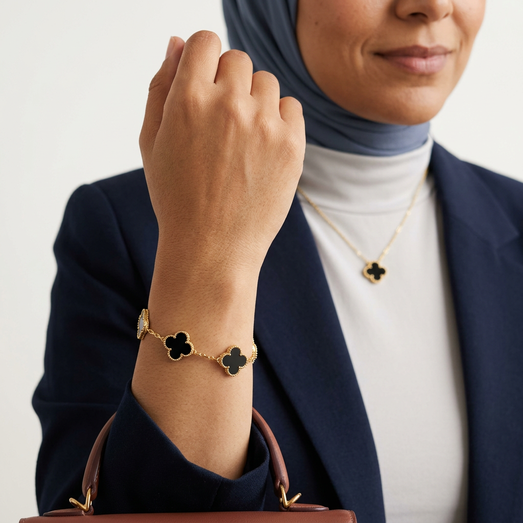 Fresh model preview with larger black clover bracelet charms in focus and the matching necklace in the background