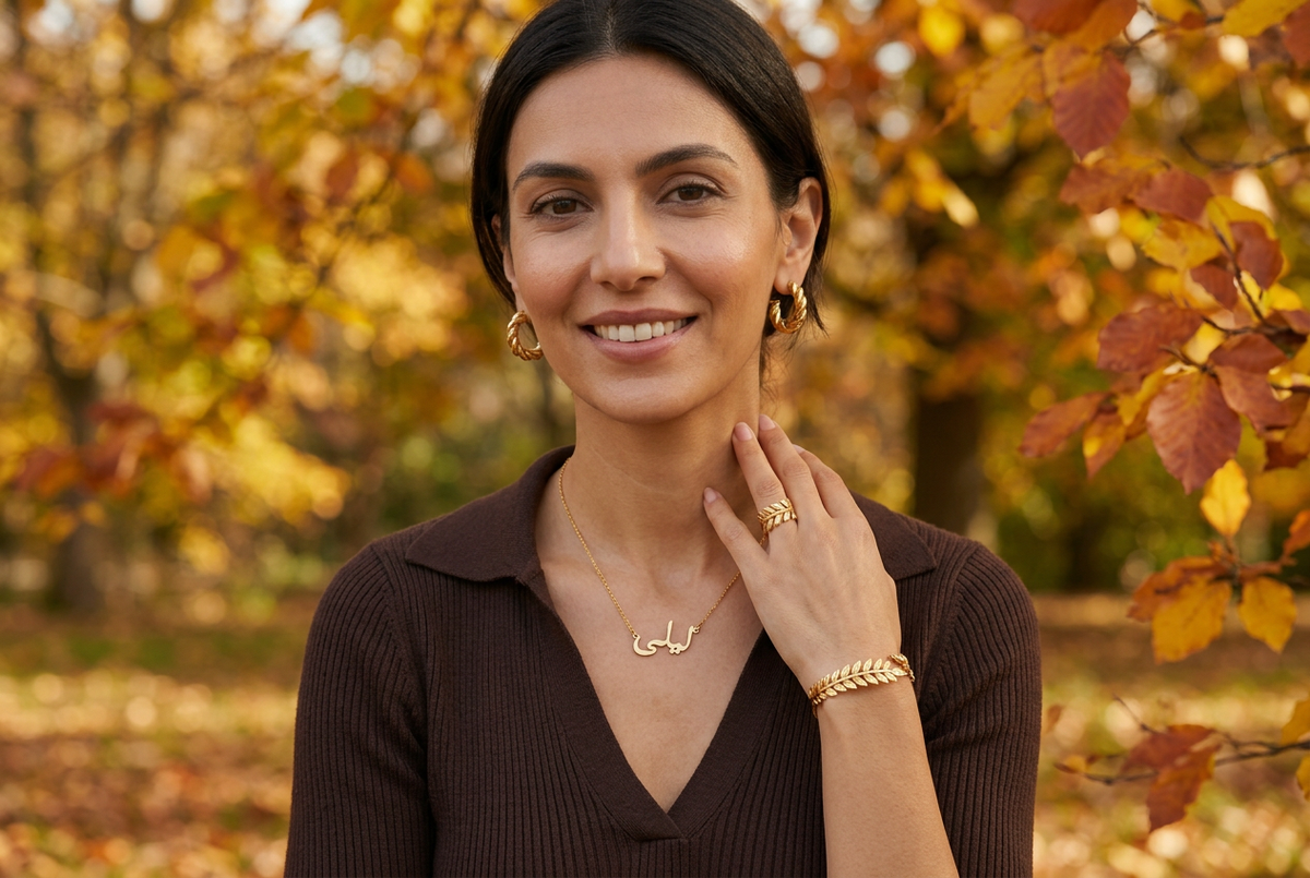 Landscape autumn jewellery hero with a smiling model and one visible hand